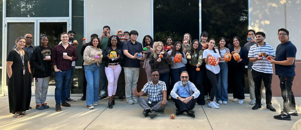 People holding decorated pumpkins group photo