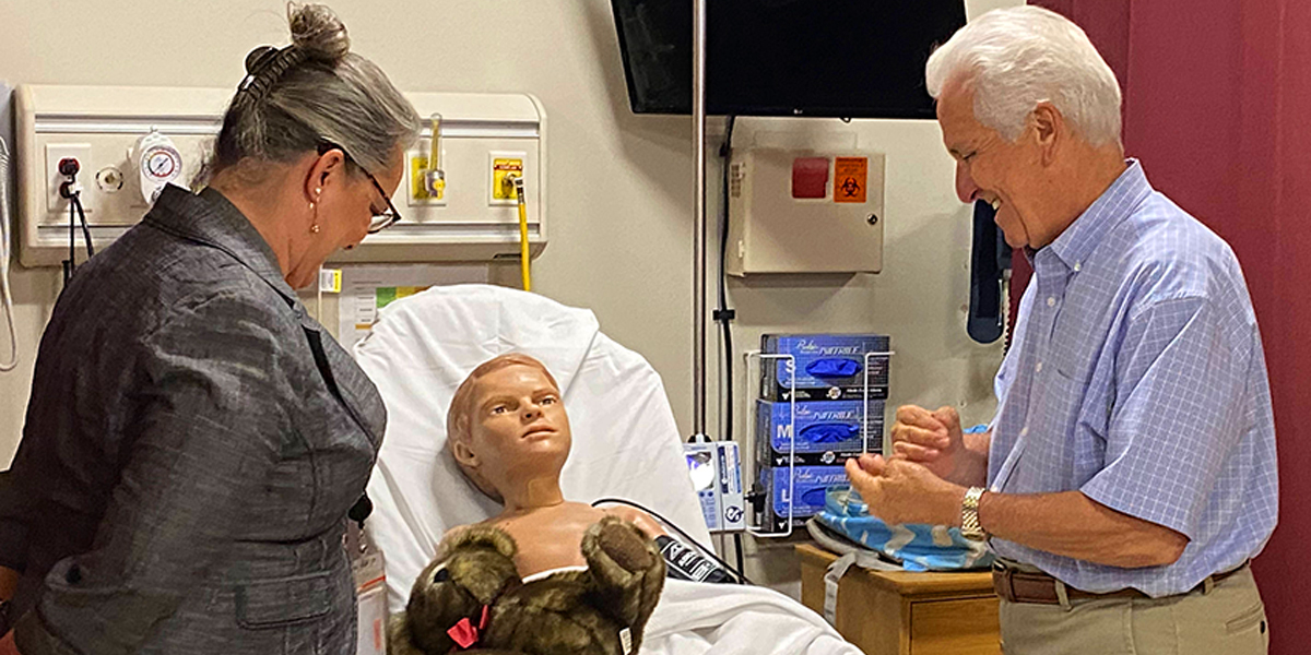 Jim Costa looking at manikin