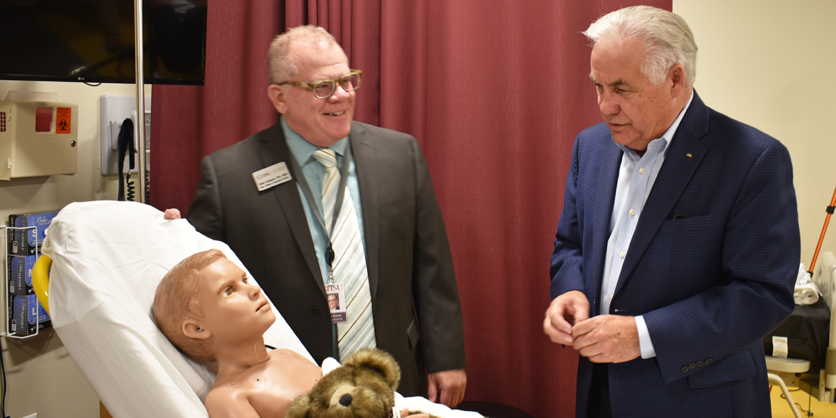 Jim Patterson looking at manikin