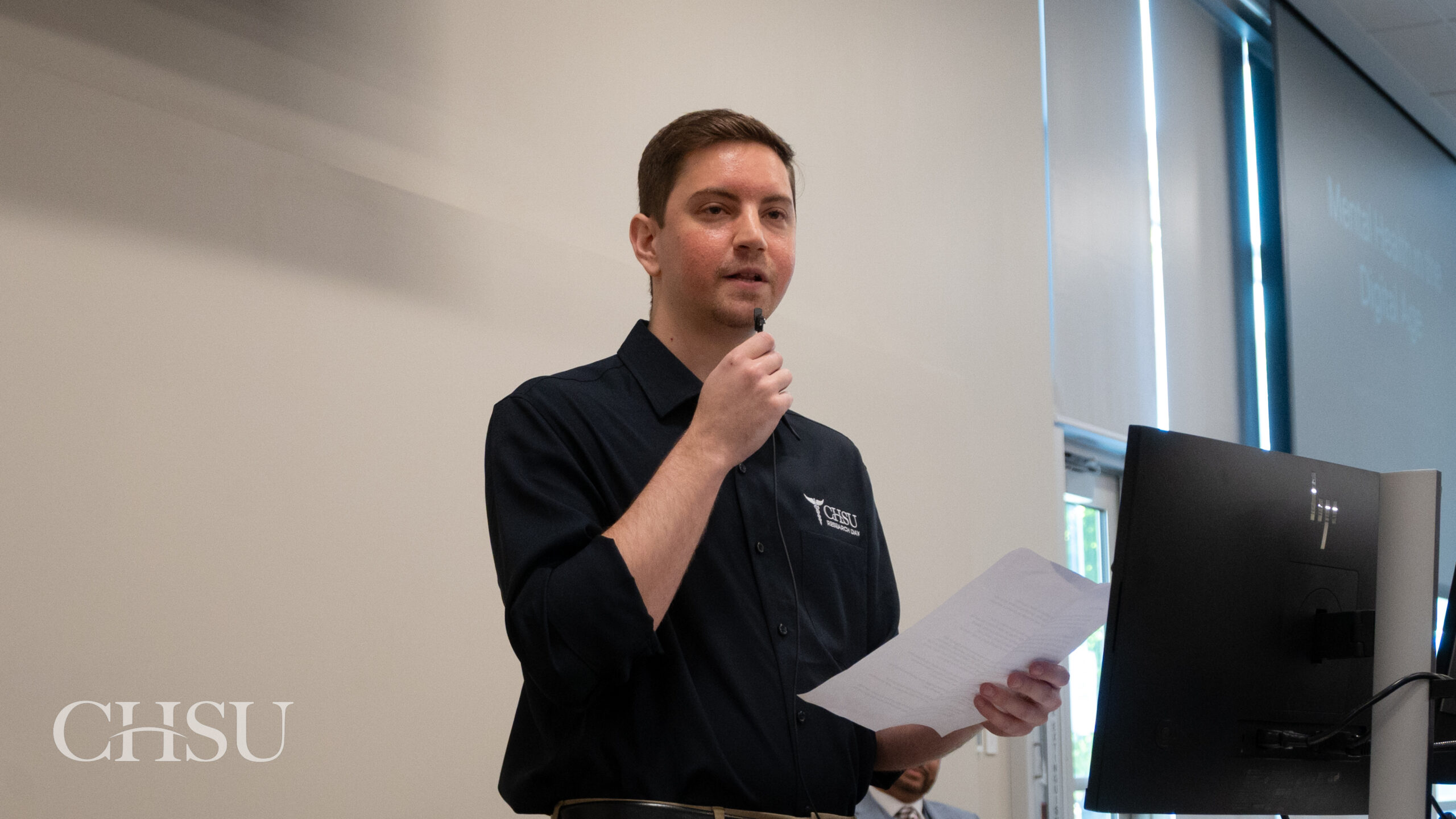 presenter at podium at CHSU Research Day