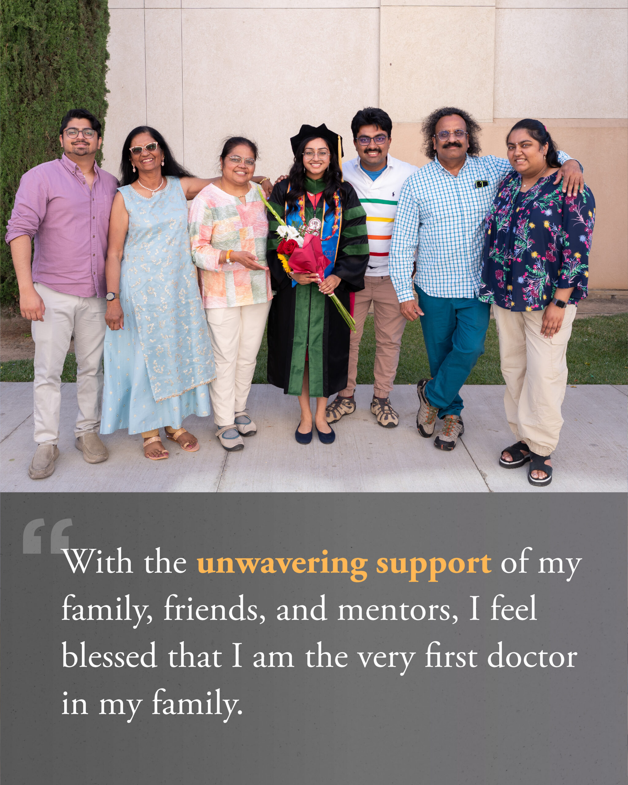 Female in graduate regalia group photo with family