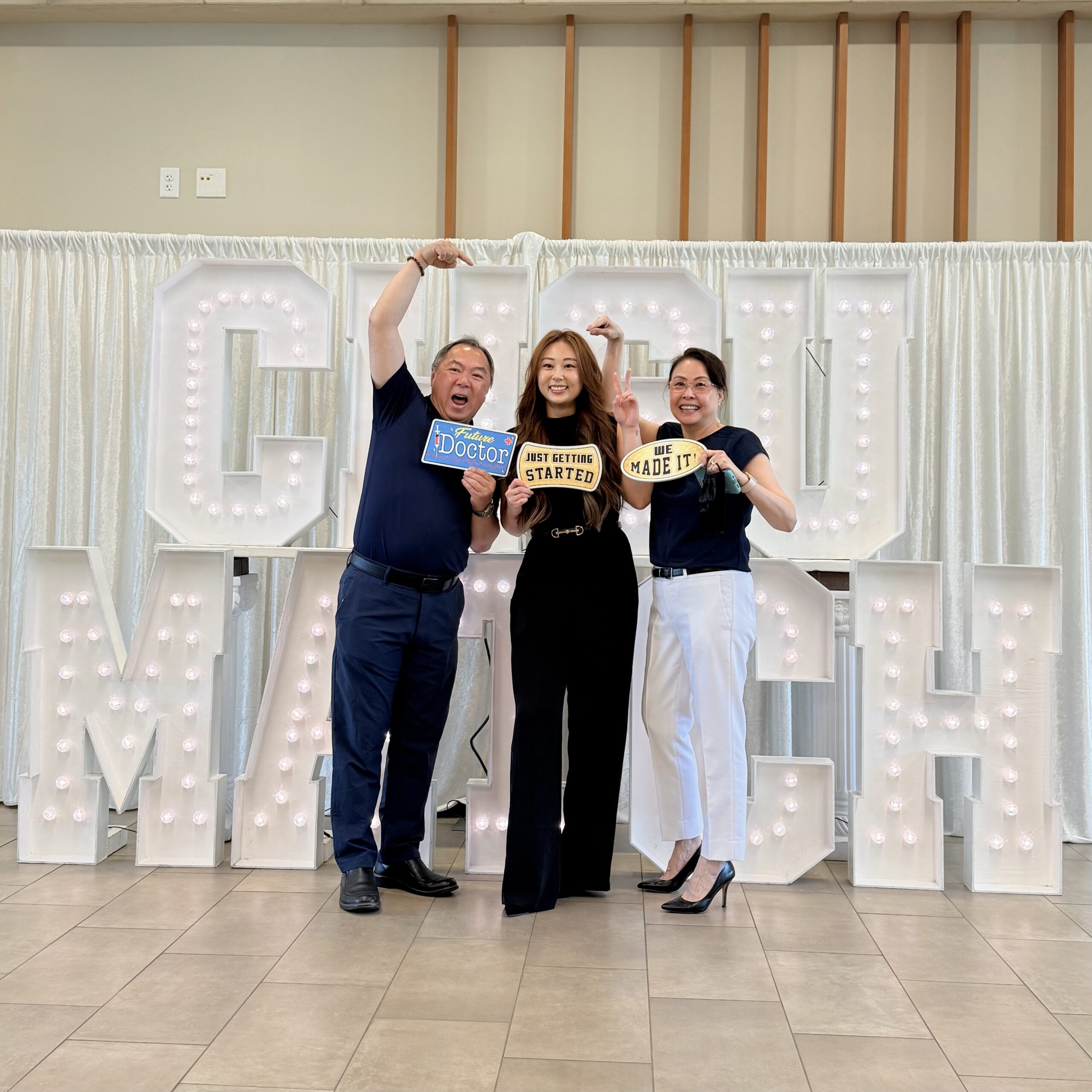 Student and family in front of CHSU Match sign
