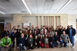group photo of medical students, staff, and physicians inside building