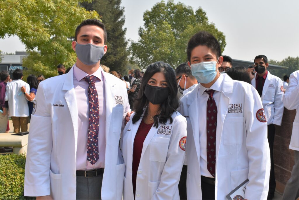 students posing in white coats