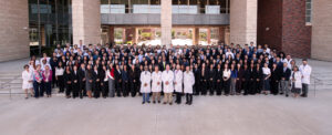 CHSU-COM class of 2030 medical students group photo on steps in front of building with faculty