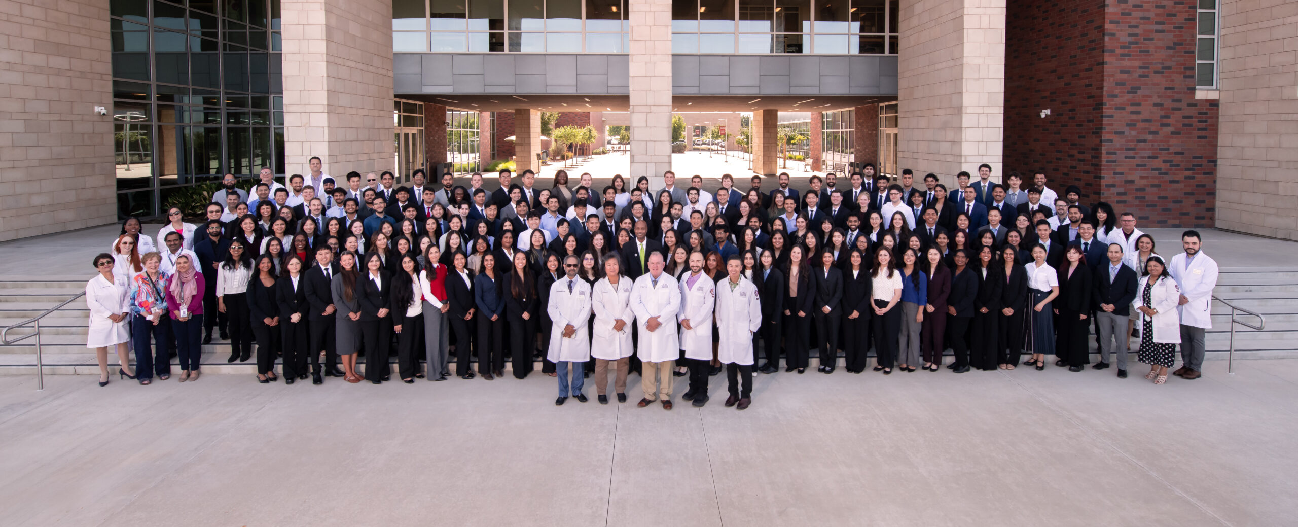 CHSU-COM class of 2030 medical students group photo on steps in front of building with faculty