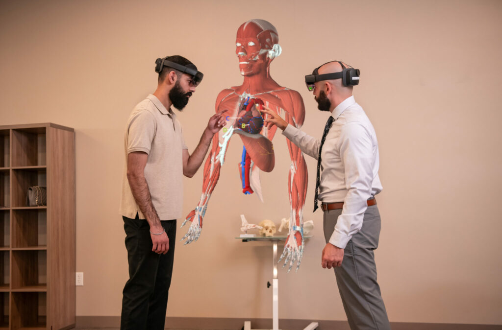 people wearing headsets looking at hologram