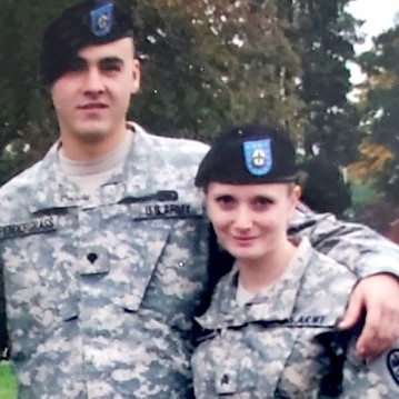 Eric Ricky Pendergrass in fatigues with female military member