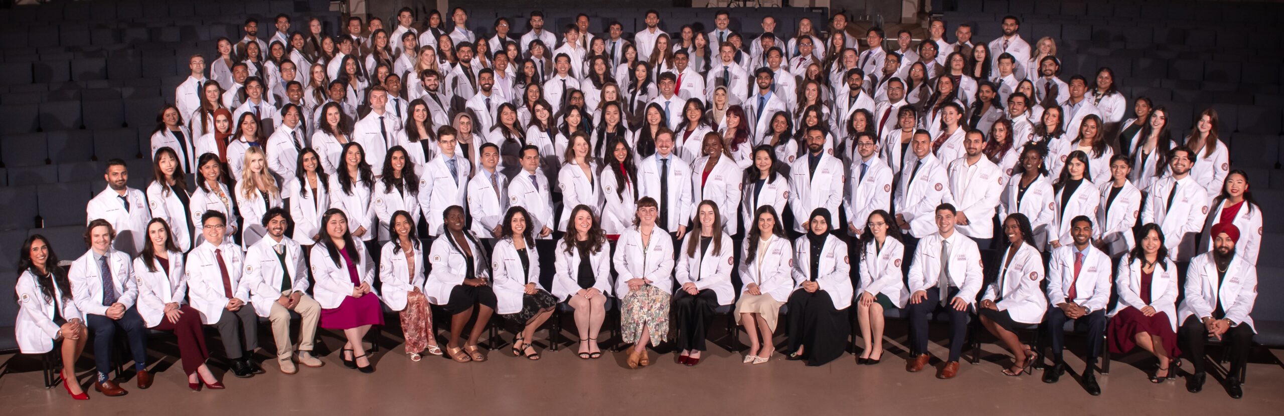 CHSU-COM class of 2029 students in group photo wearing white coats
